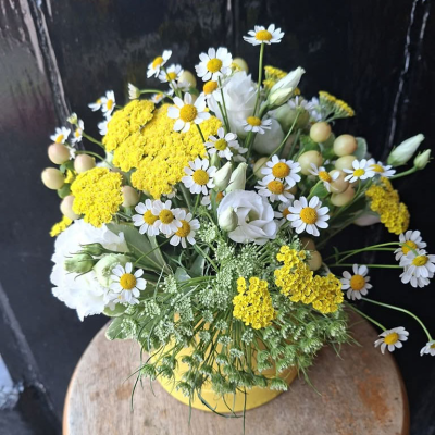 Wild Chamomile Posy - A fresh, meadow-inspired arrangement of daisy-like chamomile, sunny yellow achillea, white lisianthus and airy ammi, gathered with soft grasses. Simple, natural and full of countryside charm.