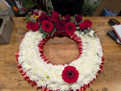 Massed Wreath - A classic circular wreath with bold contrasting tones, created to honour a loved one with dignity and affection.