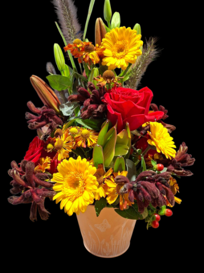 Ember Glow - A striking arrangement in rich red, golden yellow and deep burgundy tones, presented in a decorative pot for a warm, dramatic finish.