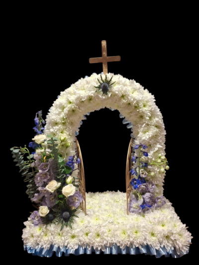 Heavenly Passage - An impressive funeral tribute featuring a floral gateway in classic white with soft blue and purple accents.