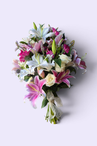 Loving Grace - An elegant tied sheaf in soft pink and white tones, beautifully finished with fresh greenery.