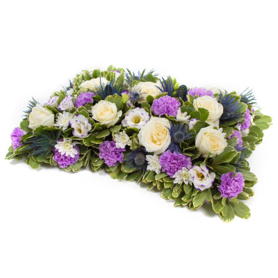 Pillow - A beautiful pillow tribute in soft white and purple tones, lovingly arranged as a peaceful and heartfelt farewell.