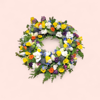 Colourful Garden Funeral Wreath - A beautiful open funeral wreath filled with a vibrant mix of colourful flowers and fresh greenery, creating a natural and heartfelt tribute.