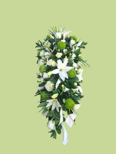 Peaceful White Funeral Spray - An elegant funeral spray featuring fresh white and green flowers with rich complementary foliage, creating a graceful and peaceful farewell.