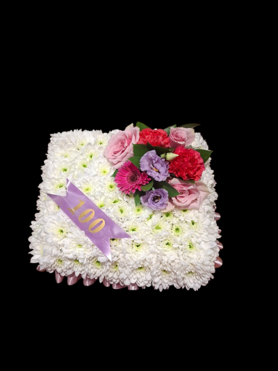 Lasting Love Funeral Cushion - A traditional white funeral cushion finished with a colourful floral spray and personalised banner for a meaningful and heartfelt farewell.