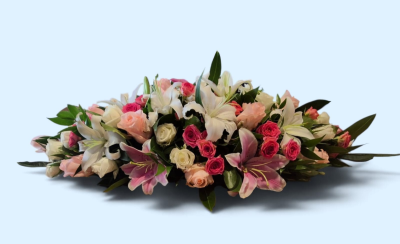 Loving Embrace Casket Spray - A beautiful casket spray featuring soft pink and white flowers with fresh greenery, creating an elegant and heartfelt farewell.